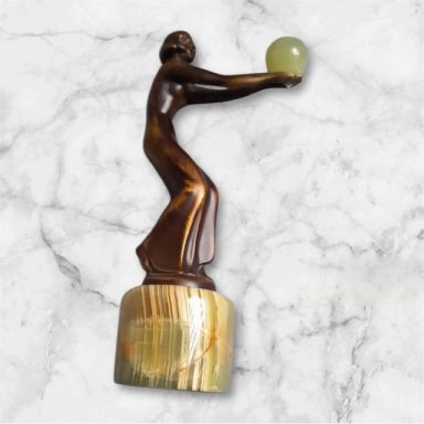 Statuette of lady with marble ball
